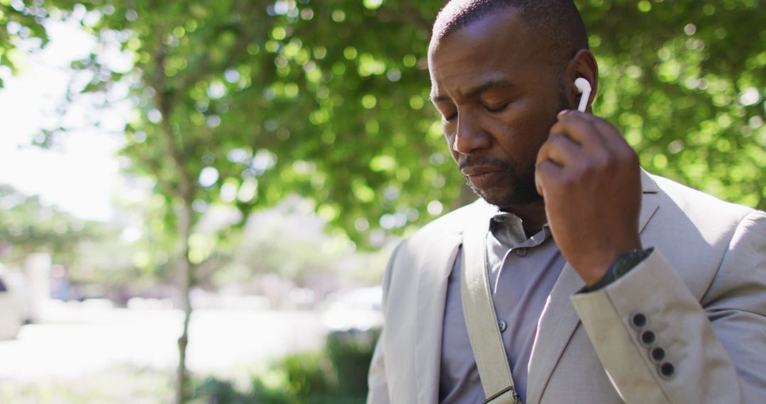 City Dweller Wearing Earphones Using Smartphone Outdoors