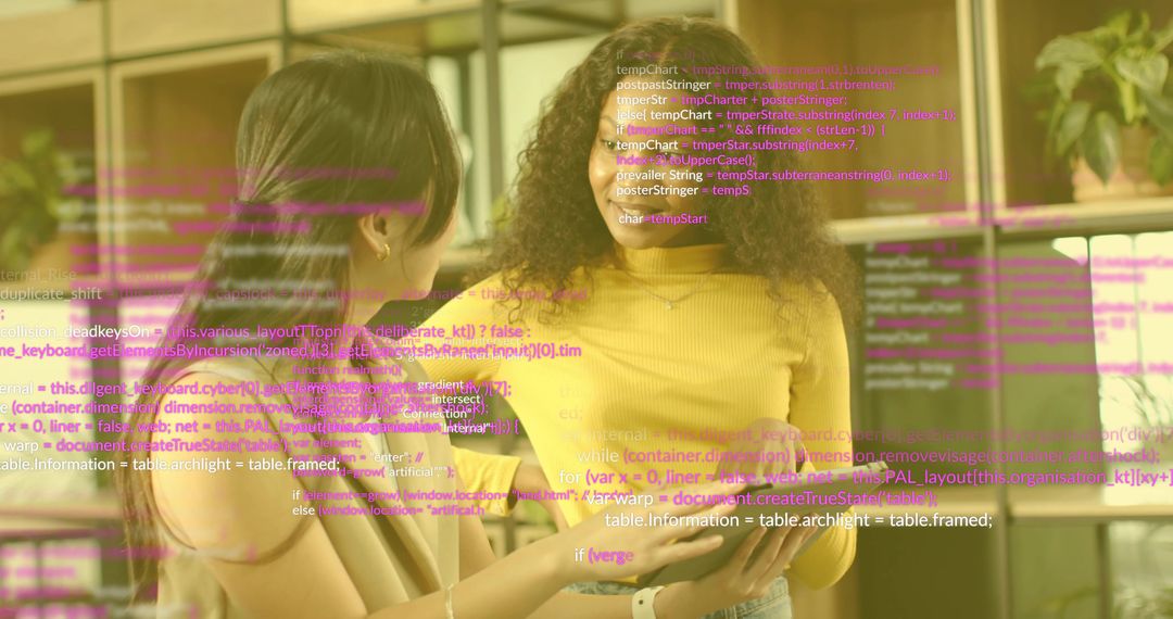 Female Developers Collaborating on Tablet with Code Overlay