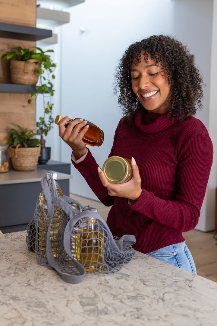 Woman Unpacking Organic Products in Eco-Friendly Kitchen Setting