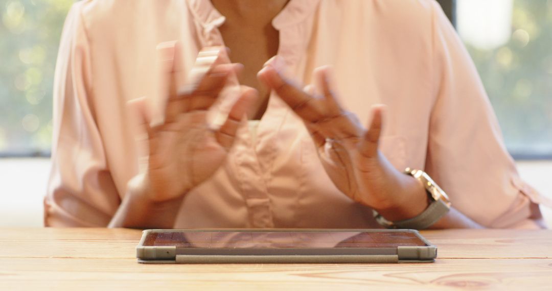 Focused Businesswoman Engaging with Tablet at Workspace