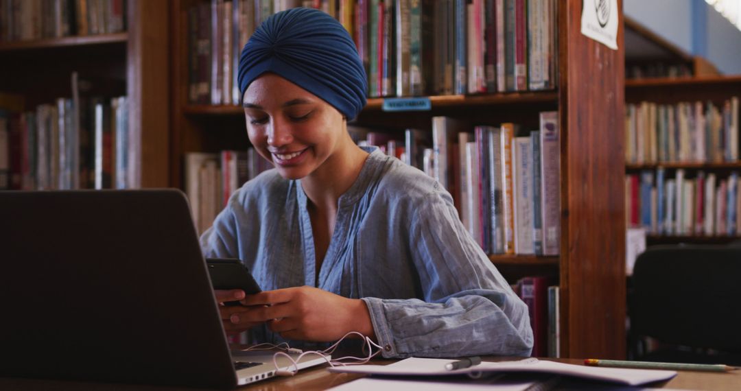 Young Woman in Turban Studying on Laptop in Library - Free Images, Stock Photos and Pictures on Pikwizard.com