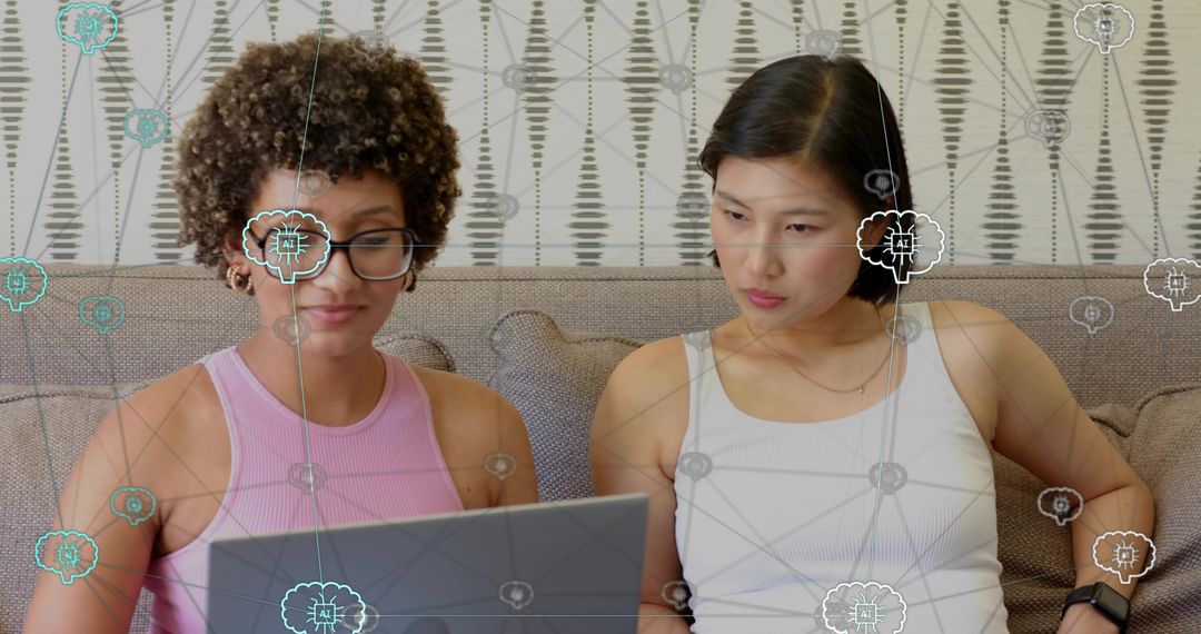 Collaborating two women using laptop with AI network overlay on sofa for remote teamwork