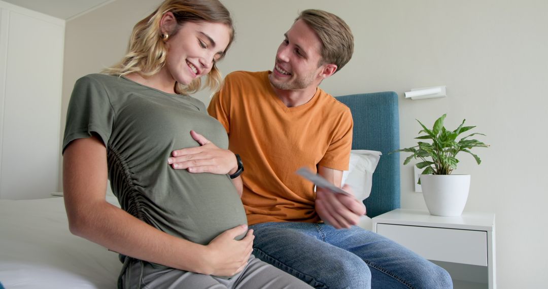 Expecting Couple Engaging in Joyful Moment at Home