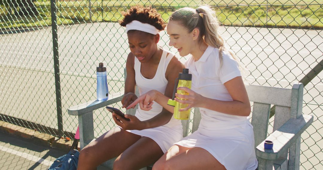 Young Female Tennis Players Relaxing and Using Phone During Break - Free Images, Stock Photos and Pictures on Pikwizard.com