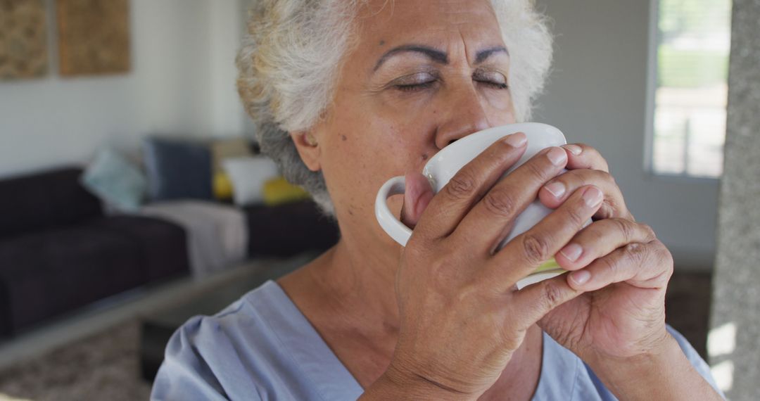 Senior Woman Savoring Hot Drink Indoors - Free Images, Stock Photos and Pictures on Pikwizard.com