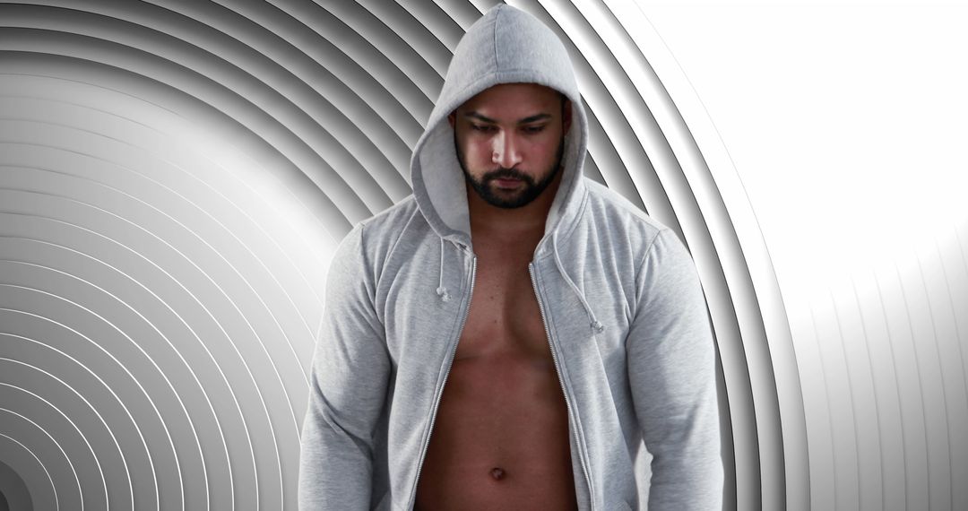 Confident Man with Hoodie in Modern Geometric Background - Free Images, Stock Photos and Pictures on Pikwizard.com