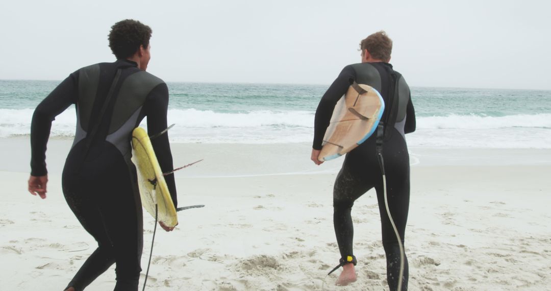 Surfers Enthusiastically Running Towards Ocean