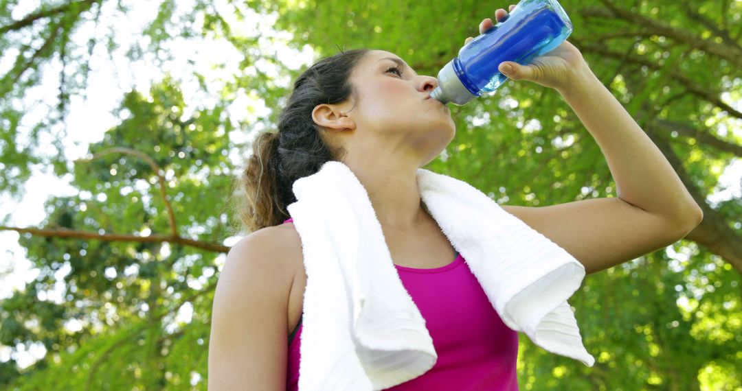 Woman Hydrating After Outdoor Workout in a Park - Free Images, Stock Photos and Pictures on Pikwizard.com