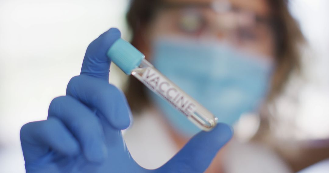 Scientist Holding Vaccine Test Tube in Laboratory Setting - Free Images, Stock Photos and Pictures on Pikwizard.com