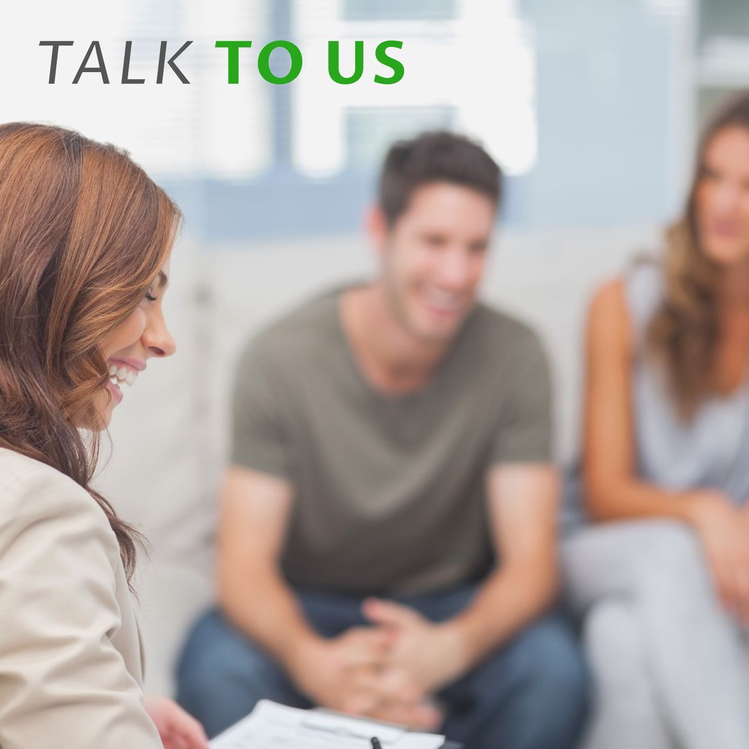 Smiling Counselor Advising Young Couple in Warm Setting
