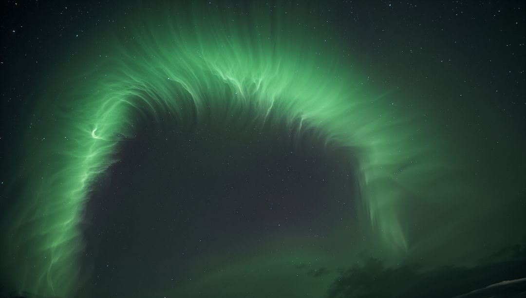 Emerald Aurora Arch Dancing Across Starry Polar Sky with Wispy Curtains and Distant Horizon