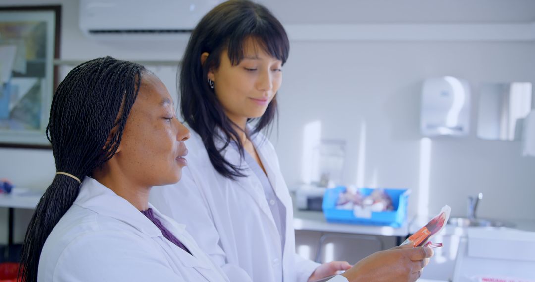 Two Female Scientists Working in Laboratory Analyzing Results on Tablet - Free Images, Stock Photos and Pictures on Pikwizard.com