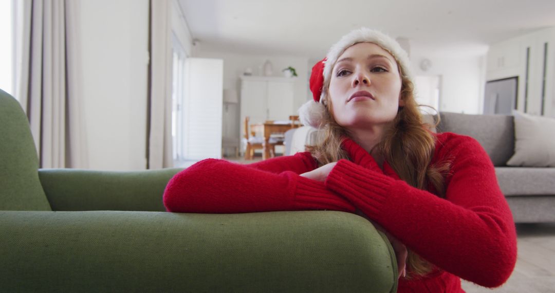 Woman in Santa Hat Relaxing at Home during Christmas Season - Free Images, Stock Photos and Pictures on Pikwizard.com