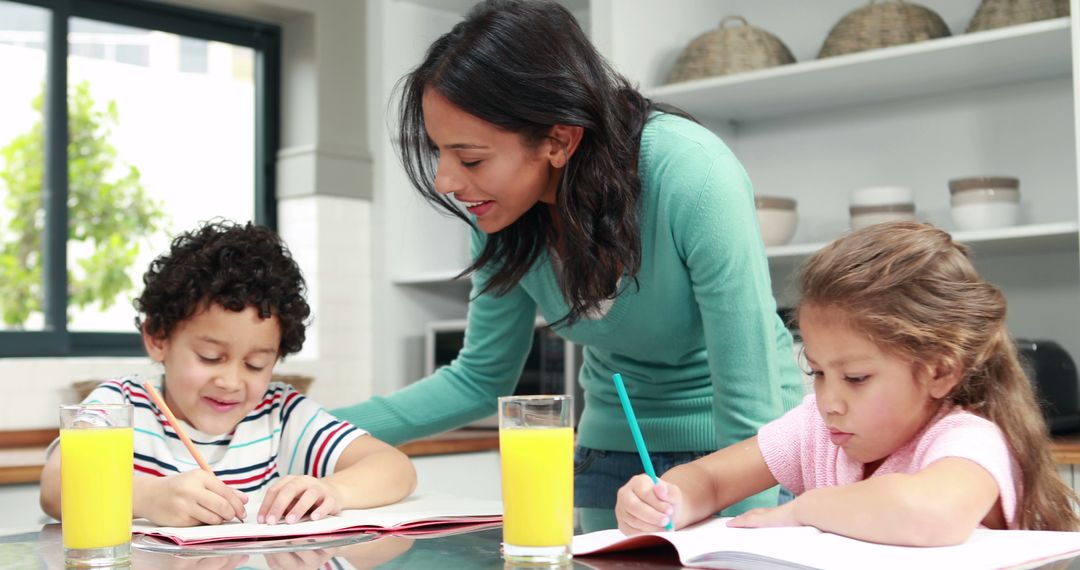 Mother Helping Kids with Homework in Kitchen - Free Images, Stock Photos and Pictures on Pikwizard.com