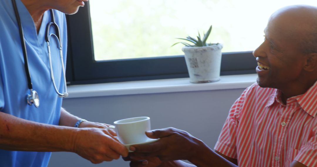 Nurse Offering Cup to Elderly Patient During Healthcare Visit - Free Images, Stock Photos and Pictures on Pikwizard.com