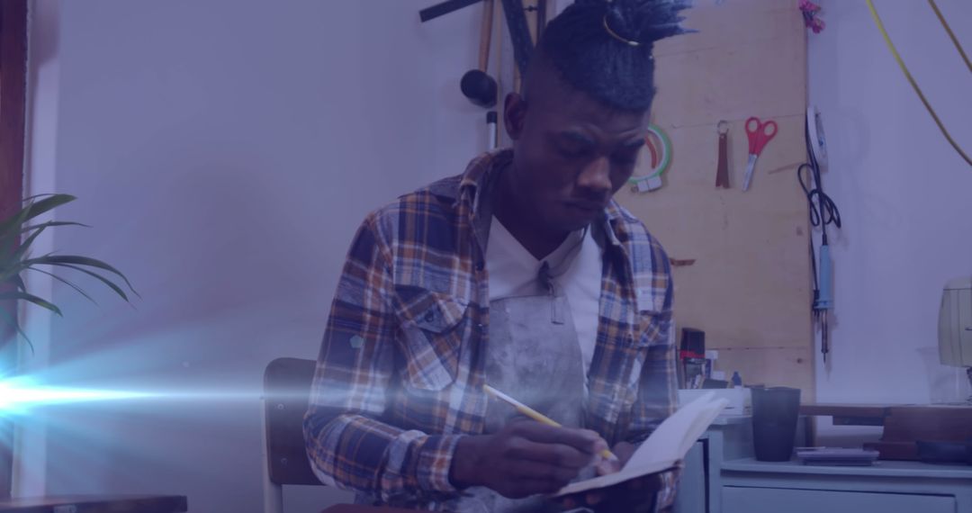 Focused Craftsman Writing Ideas in Workshop