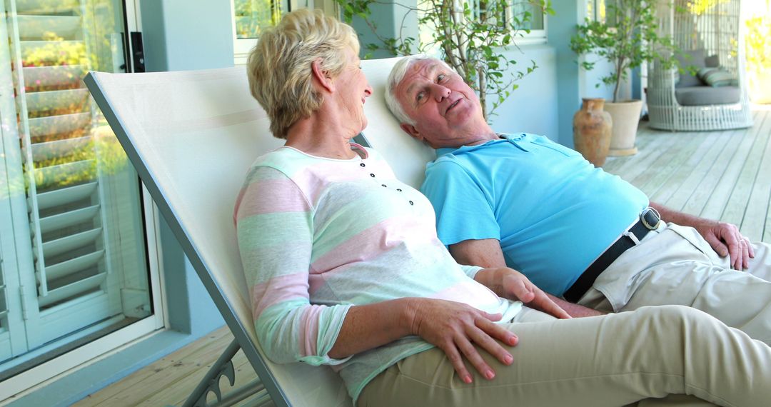 Senior Couple Relaxing on Lounge Chairs on Outdoor Patio - Free Images, Stock Photos and Pictures on Pikwizard.com