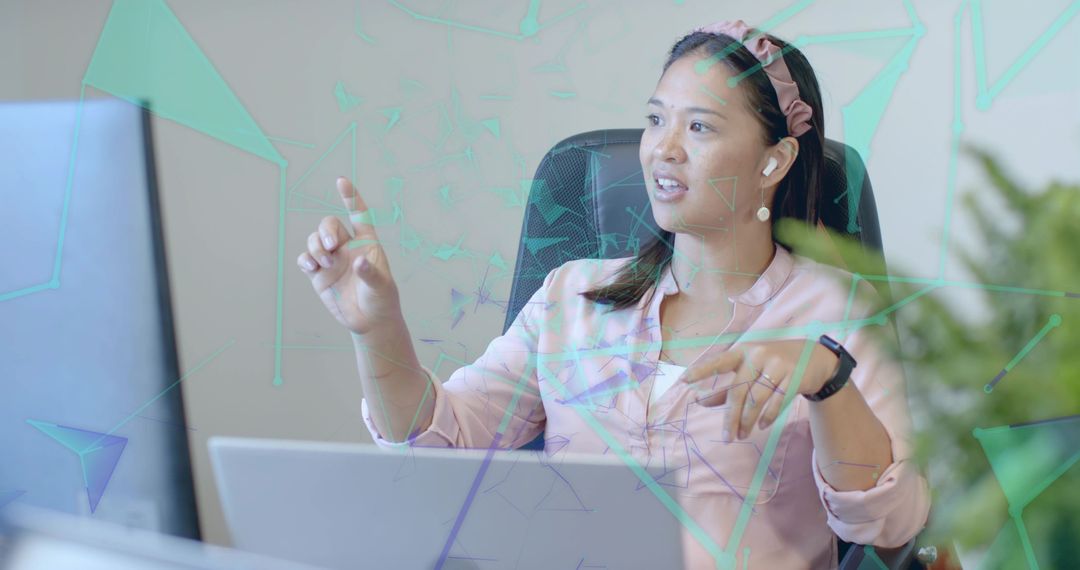 Asian Businesswoman Engaging with Technology Interface in Office