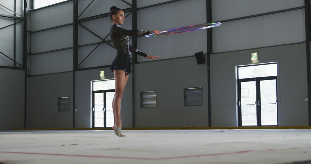 Graceful Gymnast Practicing with Hula Hoop Indoors