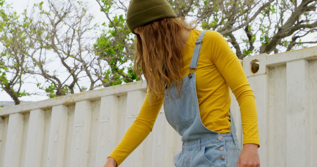 Portrait of Woman Wearing Overalls Outdoors in Beanie - Free Images, Stock Photos and Pictures on Pikwizard.com