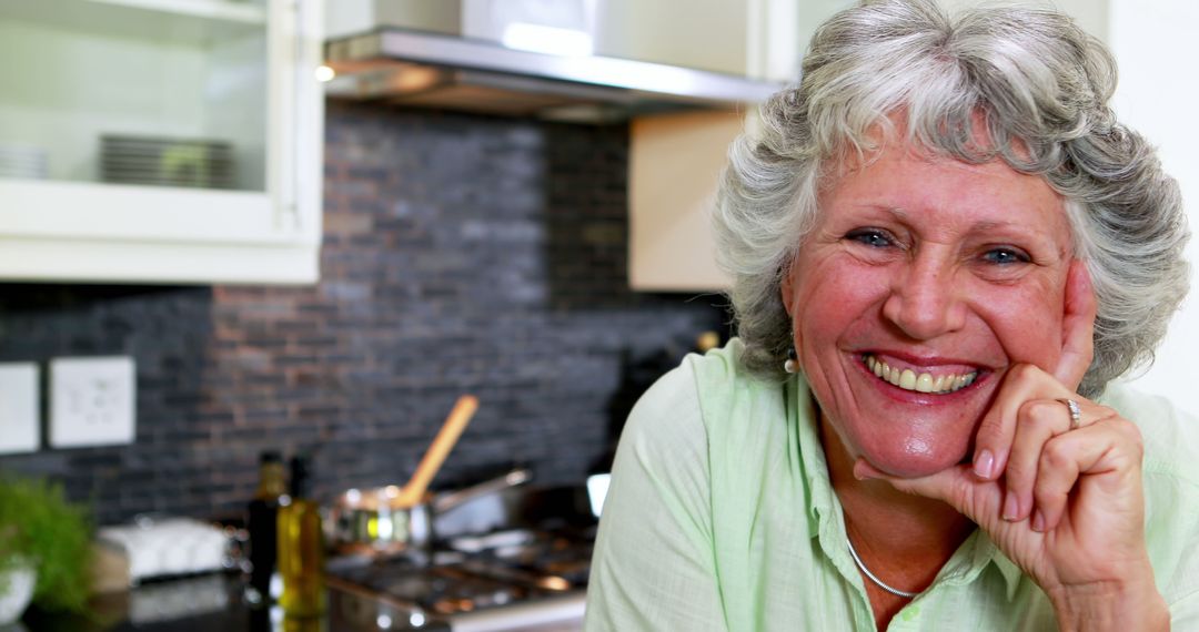 Happy Senior Woman Smiling in Modern Kitchen - Free Images, Stock Photos and Pictures on Pikwizard.com