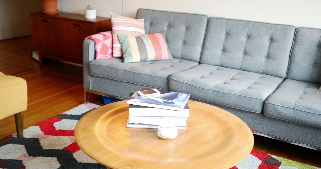 Modern Living Room with Gray Sofa and Round Wooden Coffee Table - Free Images, Stock Photos and Pictures on Pikwizard.com