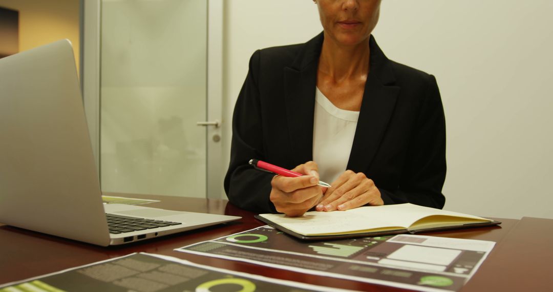 Professional Woman Reviewing Documents at Workspace - Free Images, Stock Photos and Pictures on Pikwizard.com