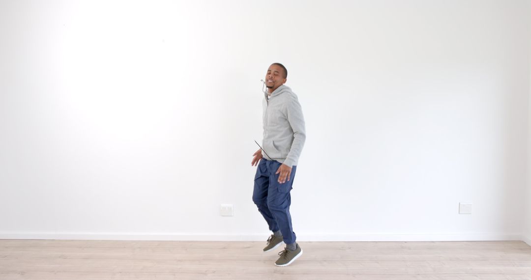 Joyful Man Jumping with Energy in Casual Attire