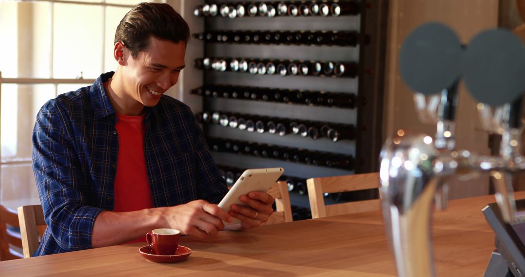 Man Enjoying Coffee and Tablet in Cafe - Free Images, Stock Photos and Pictures on Pikwizard.com