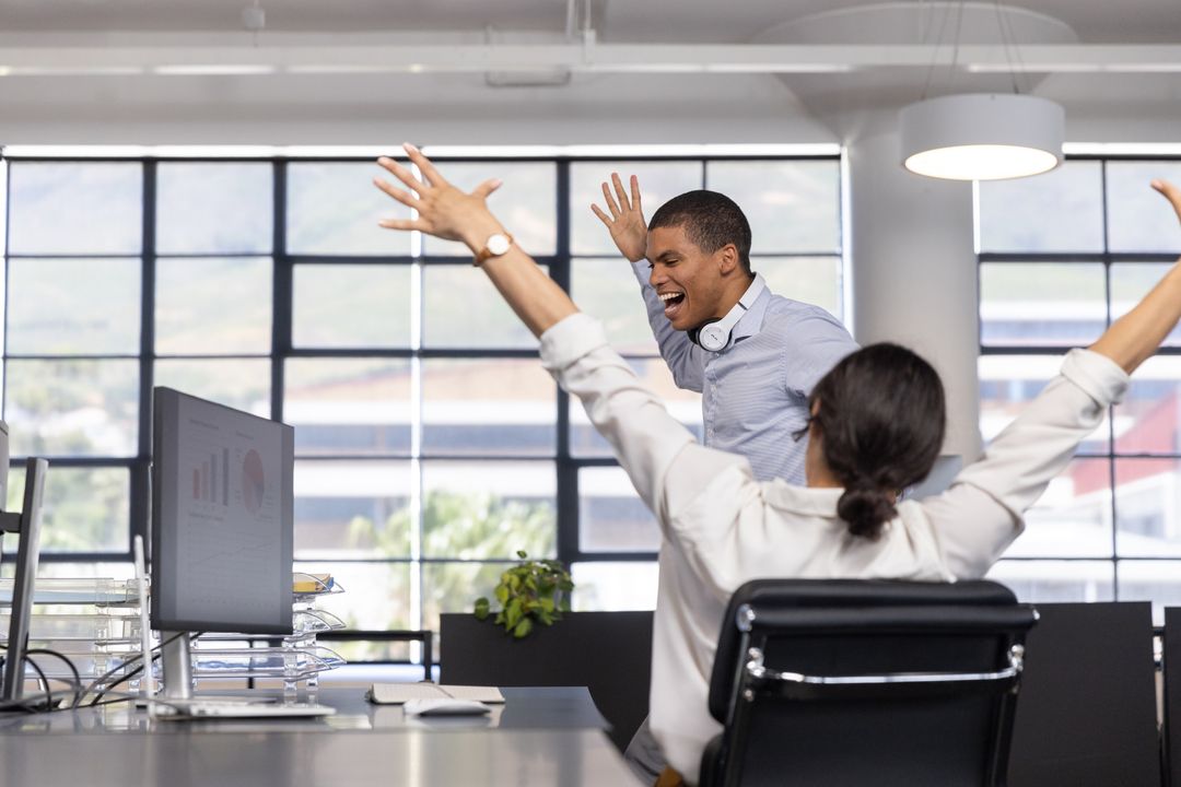 Coworkers Celebrating Success in Vibrant Office Environment
