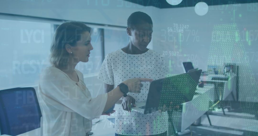 Two Diverse Female Colleagues Discussing Financial Data in Modern Office