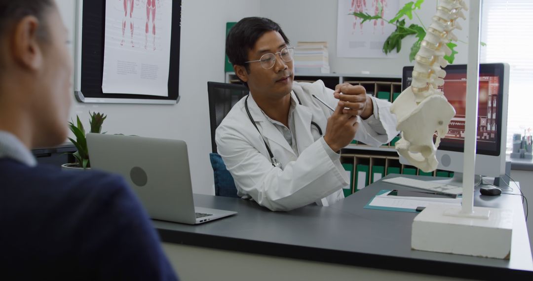 Doctor Explaining Spinal Anatomy to Patient in Medical Office - Free Images, Stock Photos and Pictures on Pikwizard.com