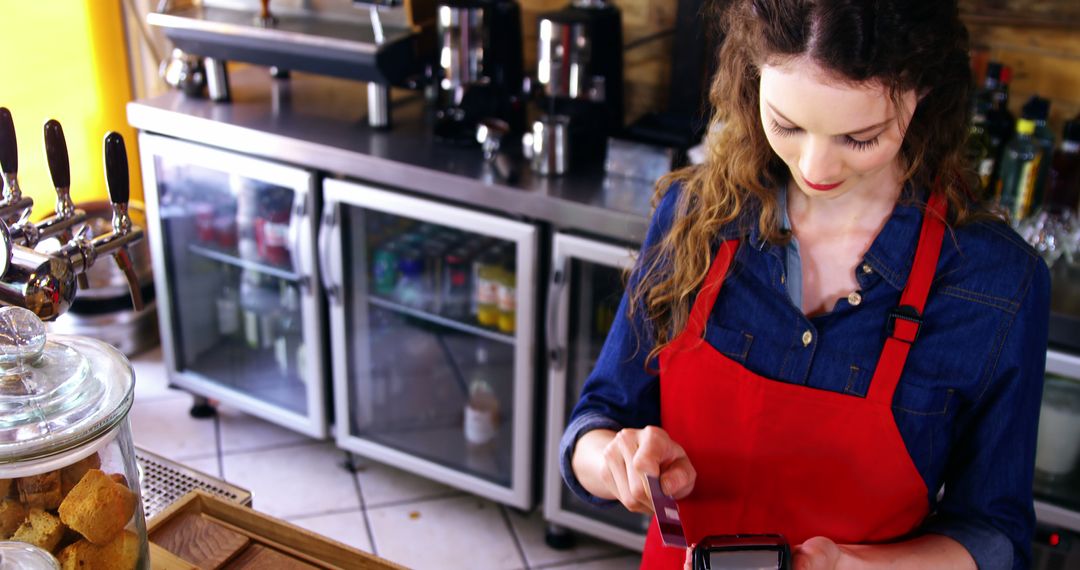 Young Barista in Red Apron Using Point of Sale Terminal - Free Images, Stock Photos and Pictures on Pikwizard.com