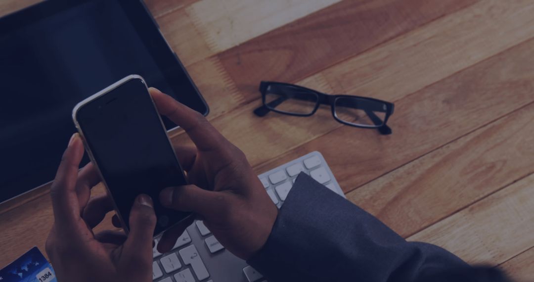 Businessperson Working on Smartphone at Workspace