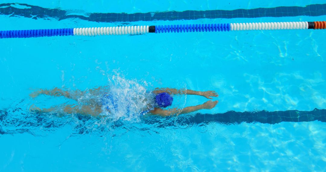 Top-Down View of Swimmer in Blue Water Pool - Free Images, Stock Photos and Pictures on Pikwizard.com