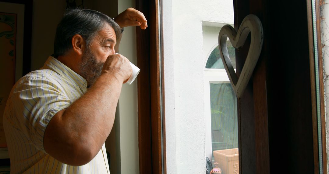 Senior Man Drinking Coffee by Window in Morning Light - Free Images, Stock Photos and Pictures on Pikwizard.com