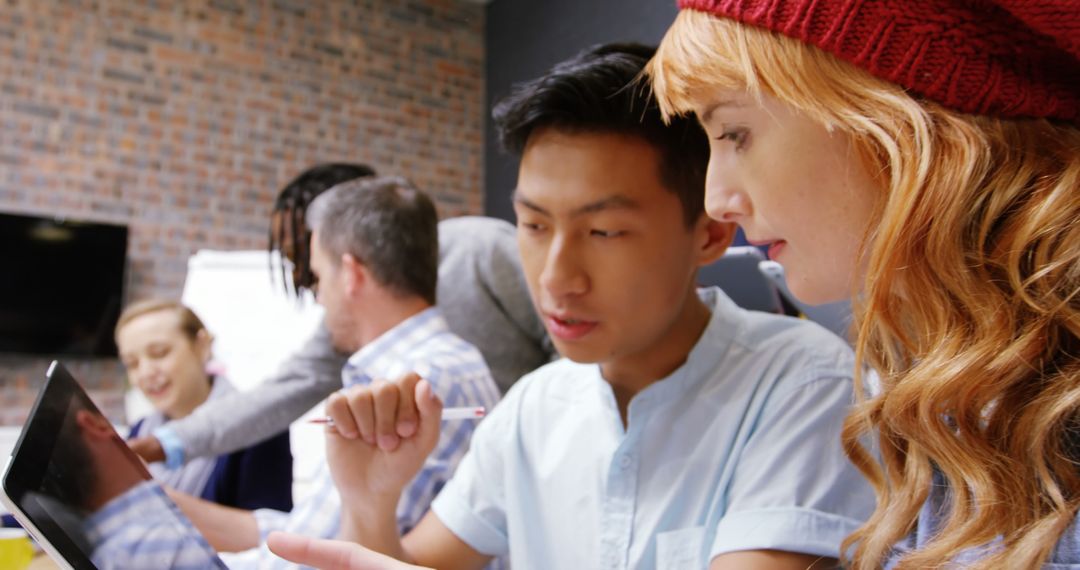 Focused Diverse Team Collaborating with Tablet Technology