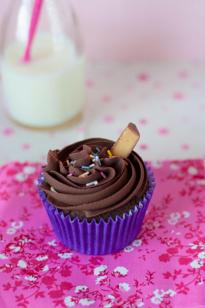 Chocolate Cupcake with Sprinkles and Milk Bottle on Floral Cloth - Free Images, Stock Photos and Pictures on Pikwizard.com