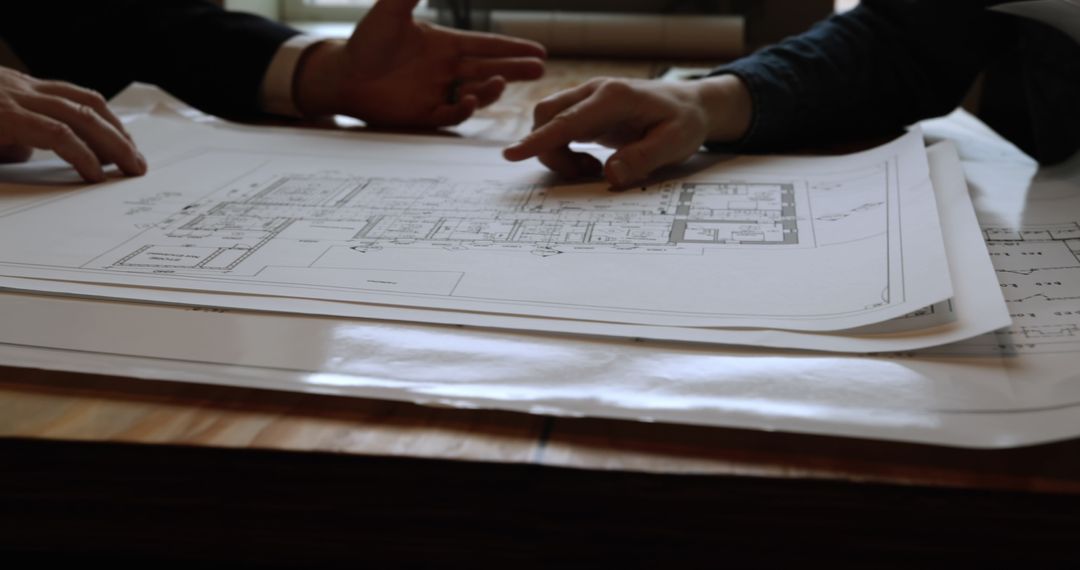 Architects Reviewing Architectural Plans During Meeting