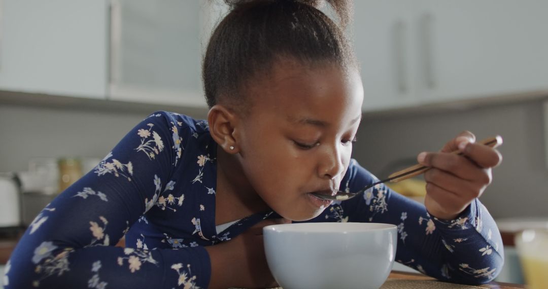 Young Girl Eating Breakfast Cereal - Free Images, Stock Photos and Pictures on Pikwizard.com