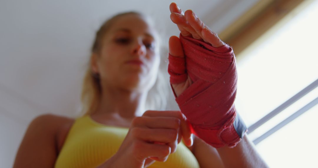 Woman Wrapping Hands with Boxing Bandages for Training - Free Images, Stock Photos and Pictures on Pikwizard.com