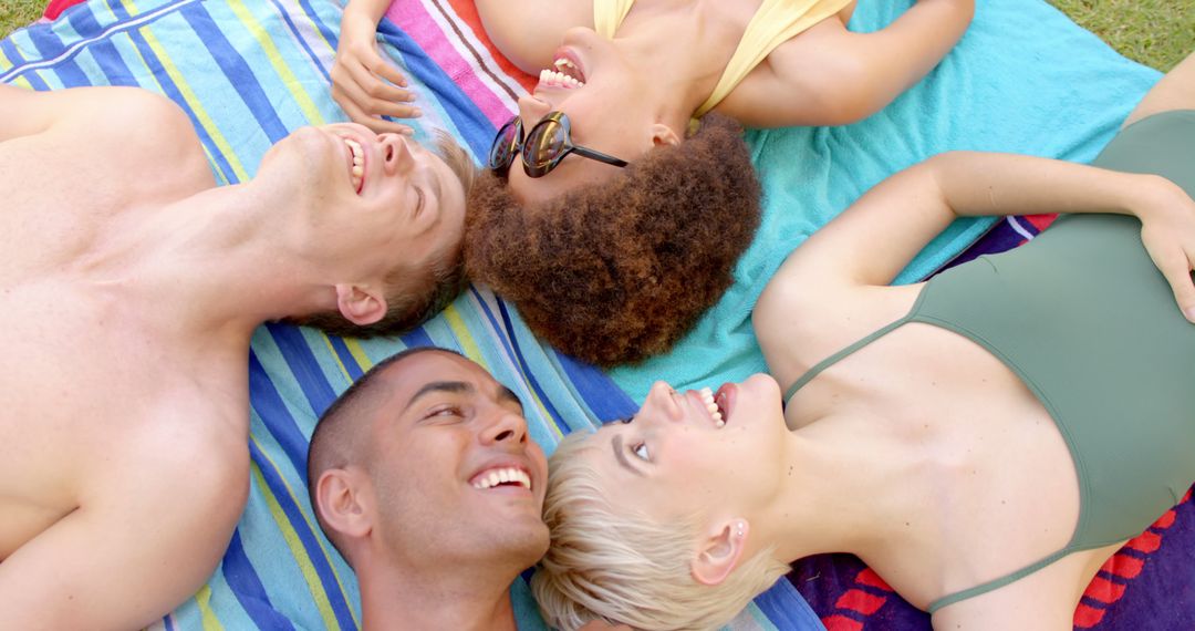 Friends Smiling and Relaxing on Beach Towels - Free Images, Stock Photos and Pictures on Pikwizard.com