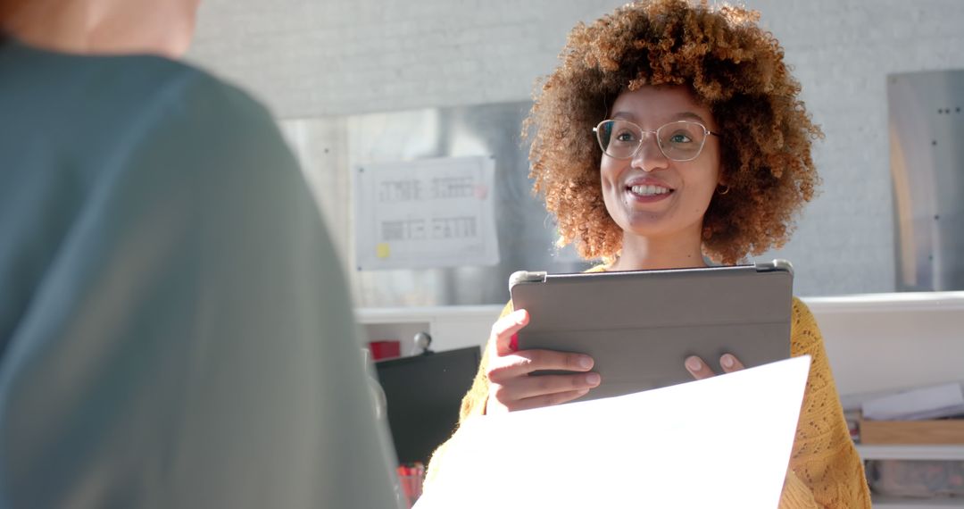 Smiling Woman with Glasses Holding Digital Tablet in Office - Free Images, Stock Photos and Pictures on Pikwizard.com