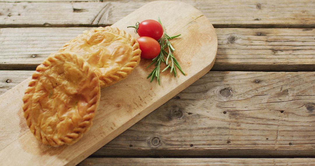 Homemade Pies on Rustic Wooden Surface with Herbs and Cherry Tomatoes