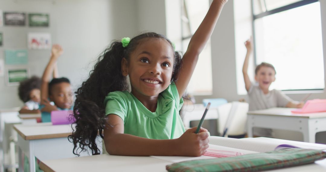 Image of happy african american girl raising hand during lesson - Free Images, Stock Photos and Pictures on Pikwizard.com