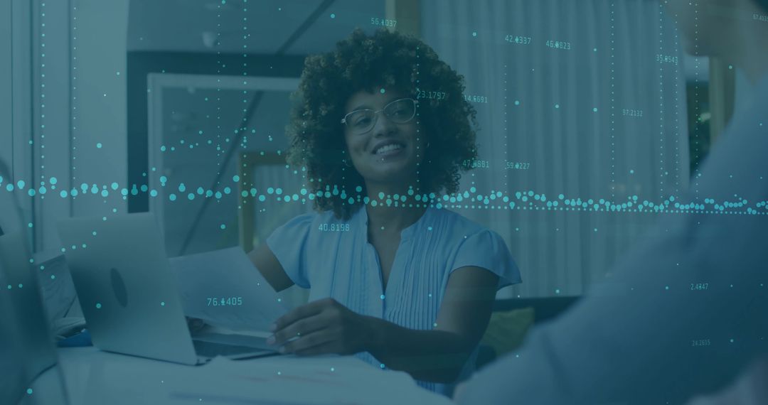 Smiling advisor reviewing documents with client in home office with laptop and data overlay