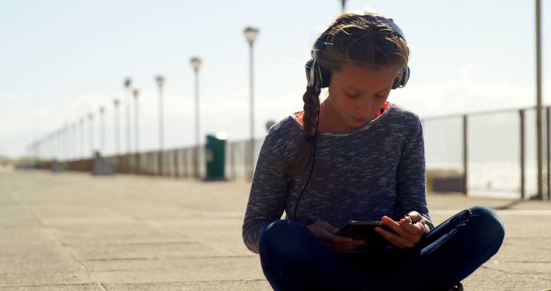 Young Girl Listening to Music on Promenade - Free Images, Stock Photos and Pictures on Pikwizard.com