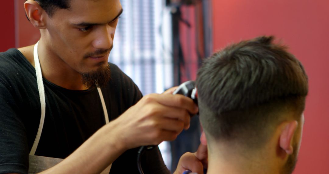 Barber Giving Haircut with Clipper to Client in Modern Barbershop - Free Images, Stock Photos and Pictures on Pikwizard.com