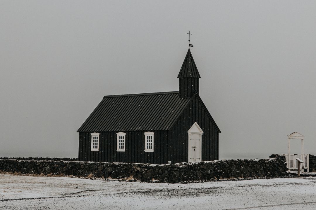 Historic Black Church in Snowy Landscape on Overcast Day - Free Images, Stock Photos and Pictures on Pikwizard.com