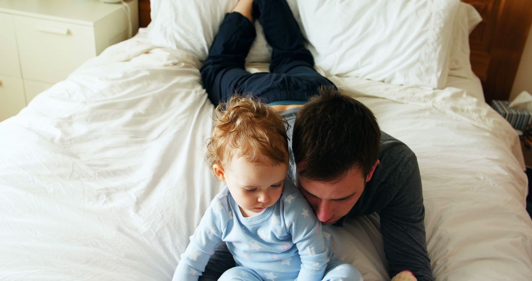 Father and Toddler Lying on Bed Together in Cozy Bedroom - Free Images, Stock Photos and Pictures on Pikwizard.com